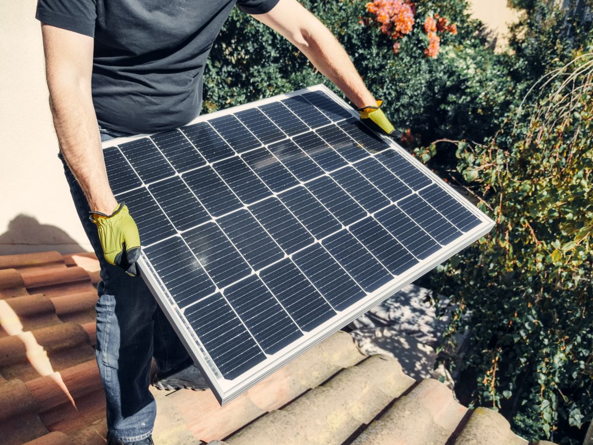 A Jaypee Solar technician fitting a solar panel